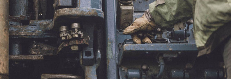 man working at a well drilling machine